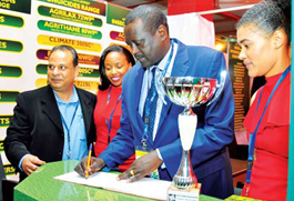 PS Dr. Lesiyampe signs visitors book at Agrichem Africa Ltd Stand.